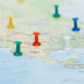 Map of North America marked with colored push pins across multiple cities.
